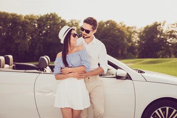 Close up cropped family portrait outdoors carefree, cheerful married family, rent transport trip, relax, chill, escape, valentine, honeymoon. Well dressed brunet driver in, femenine girlish lady