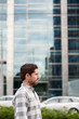 © mavoimages - Young man standing in front of buildings in the city