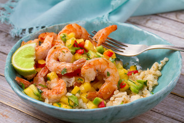 Wall Mural - Shrimps with mango avocado and red pepper salsa on cauliflower rice