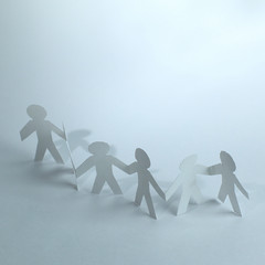 Wall Mural - group of paper men holding each other's hands