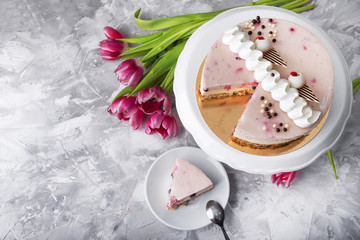 Dessert cake with tulips flowers on a background