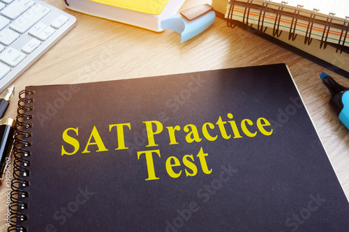 Fotomural SAT Practice Tests with textbooks on a desk.