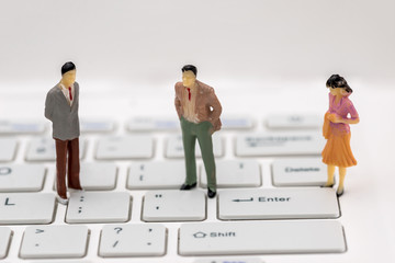 mini people on a computer keyboard