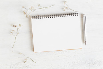 Wall Mural - flat lay photo of office desk on white background,empty notebook open on white wood table