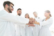 © ASDF - Doctors and nurses in a medical team stacking hands