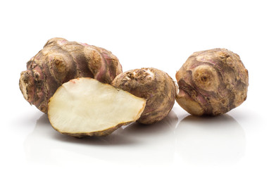 Wall Mural - Jerusalem artichoke three tubers and one half isolated on white background sweet crisp topinambur.