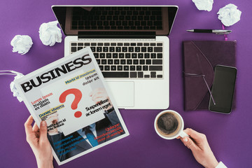 Poster - Cropped shot of businesswoman reading magazine at workplace on purple surface