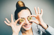 close-up portrait fashioned woman in business suit having fun with two bitcoin coins. smile and happy.