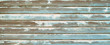 Painted and chipped paint teal wood board panels background. Rough wood texture surface with blue and green tints.