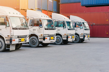 Line of cargo truck with container box for export import shipping at yard. logistic concept