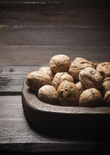 Close-up Of Walnuts In Wooden Container On Table