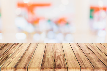 Sticker - Empty wooden table with blur shopping mall background.