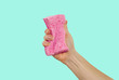 Woman's hand, holding a sponge for dishes