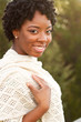 © digitalskillet1 - African American woman smiling outside.