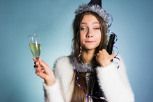 Drunk Woman In A Festive Cap Holding Champagne In Hands