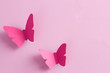 Paper butterflies on a pink background. Love and Valentine's day concept. Top view