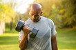 © digitalskillet1 - Fit African American man lifting weights