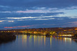 Night panorama of Georgetown suburb in Washington DC, USA. Key Bridge and Potomac River illuminated by street lights after a cloudy sunset.
