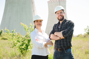 Wall Mural - two workers wearing protective helmet works at electrical power station.