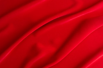 Red silk wavy background. Passion backdrop for Valentines day.