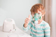 Little boy making inhalation with nebulizer at home. 
