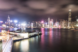 Fototapeta  - Stunning view of Hong Kong island skyline and the Star ferry pier in Kowloon at night