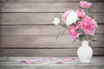 beautiful peony on old wooden background