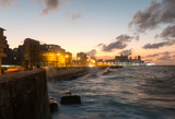 Fototapeta Miasto - Cubans contemplate the sunset in the famous malecon in Havana, Cuba