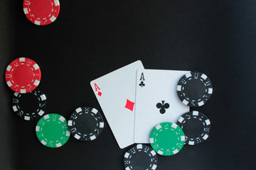 Poker chips with dices on black background. Copy space