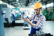 © NDABCREATIVITY - Portrait of an handsome engineer in a factory