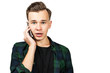 © vika33 - White young guy speaks on the phone and is surprised, isolated on a white background.