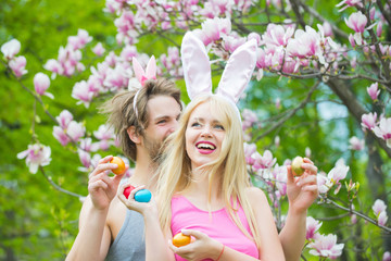 Wall Mural - couple in love with bunny ears holding colorful eggs