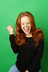 Wall Mural - Jubilant excited young woman cheering