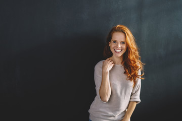 Wall Mural - Happy vivacious young redhead woman