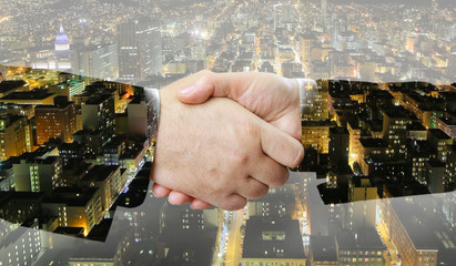 Aufkleber - Closeup of business people handshake on big city at night background 