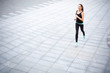 © Prostock-studio - Young woman jogging in city copy space