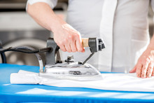 Ironing A White Shirt With Professional Iron In The Laundry