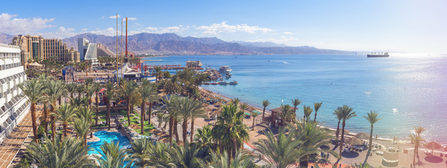 Wall Mural - Central public beach and marina in Eilat - famous resort and recreation city in Israel. This serene location is a very popular tropical getaway for Israeli and European tourists. Panoramic view

