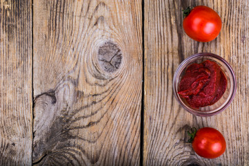 Canvas Print - Tomato paste, ketchup, cherry tomatoes on wooden table