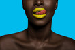 © All king of people - concept of colors with black skin afro woman mouth with tongue out, having orange lipstick
