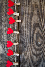 Red Hearts On Clothespins Hanging On Rope