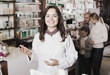 © JackF - Smiling woman pharmacist helping customers
