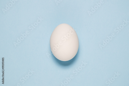 Cuadros en Lienzo Top view of white egg isolated on pale blue background.