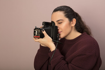 Young woman holding a vintage camera