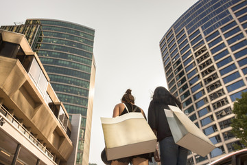 Two women with shopping bags.