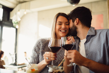 Wall Mural - Young attractive couple drinking red wine. Couple celebrating anniversary, Valentine's day or International woman's day.