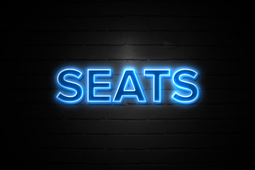 Seats neon Sign on brickwall