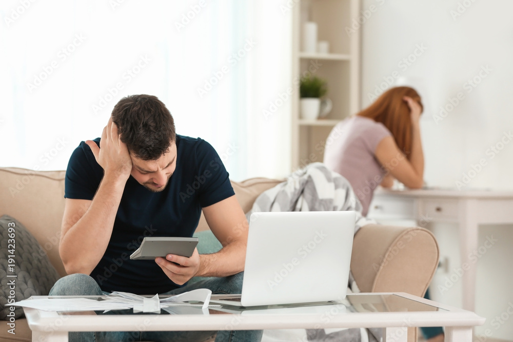 Depressed couple with money problems after quarrel at home
