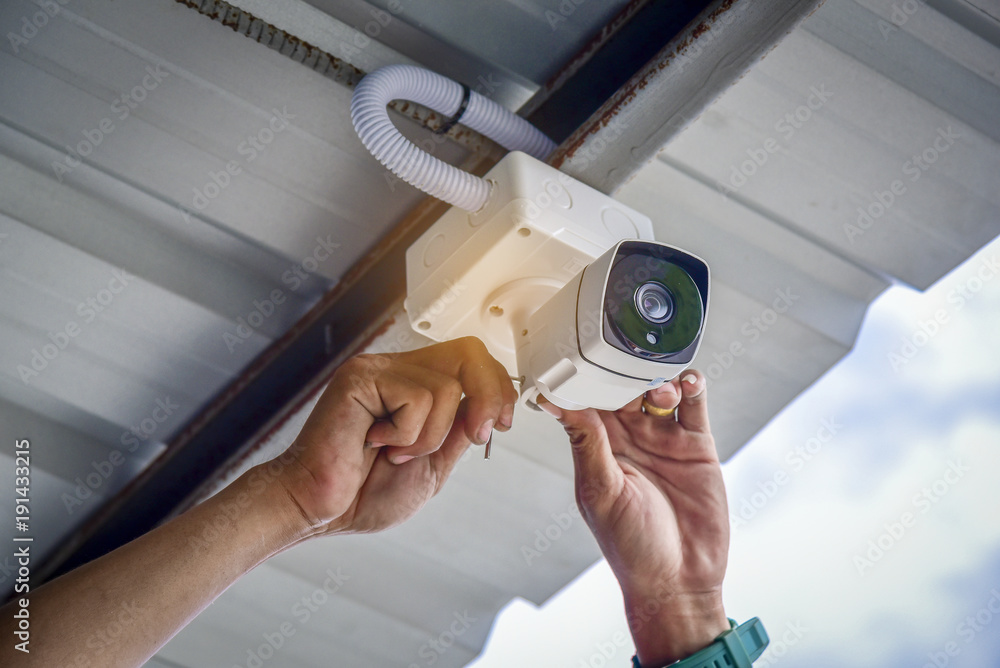 Technician installing CCTV camera system for security area  - obrazy, fototapety, plakaty 