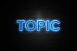 Topic neon Sign on brickwall